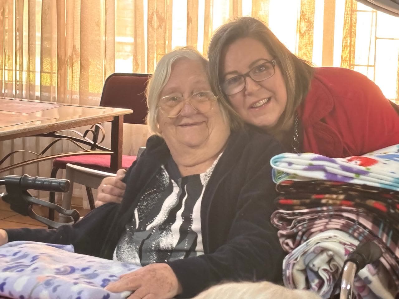 A MAP volunteer with a resident of Avondrus Frail Care Centre holding a donated fleece blanket